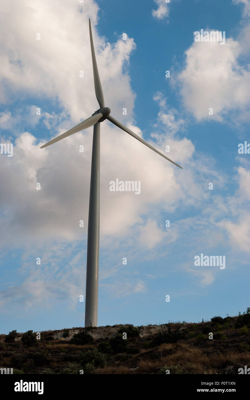 Wind turbine on the hill with cloudy sky as a background. Eco power ...