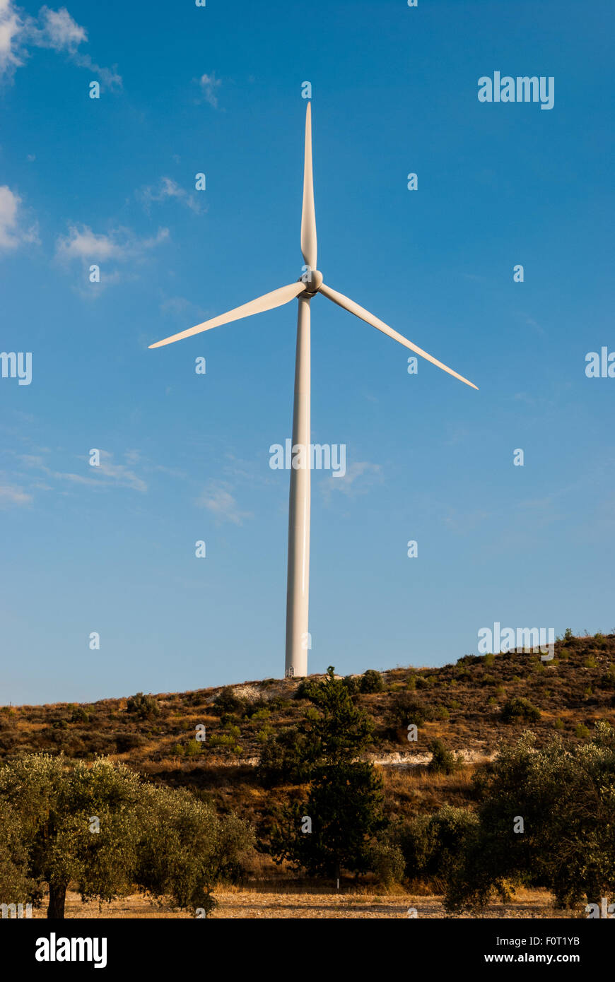 Wind turbine on the hill with blue sky as a background. Eco power Stock ...