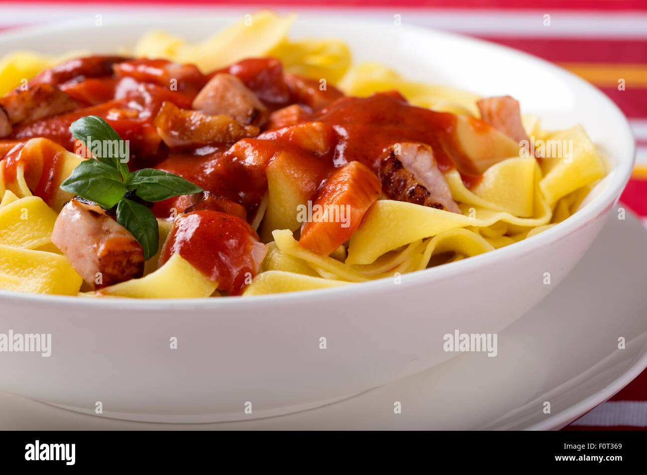 Egg tagliatelle with meat in tomato sauce Stock Photo