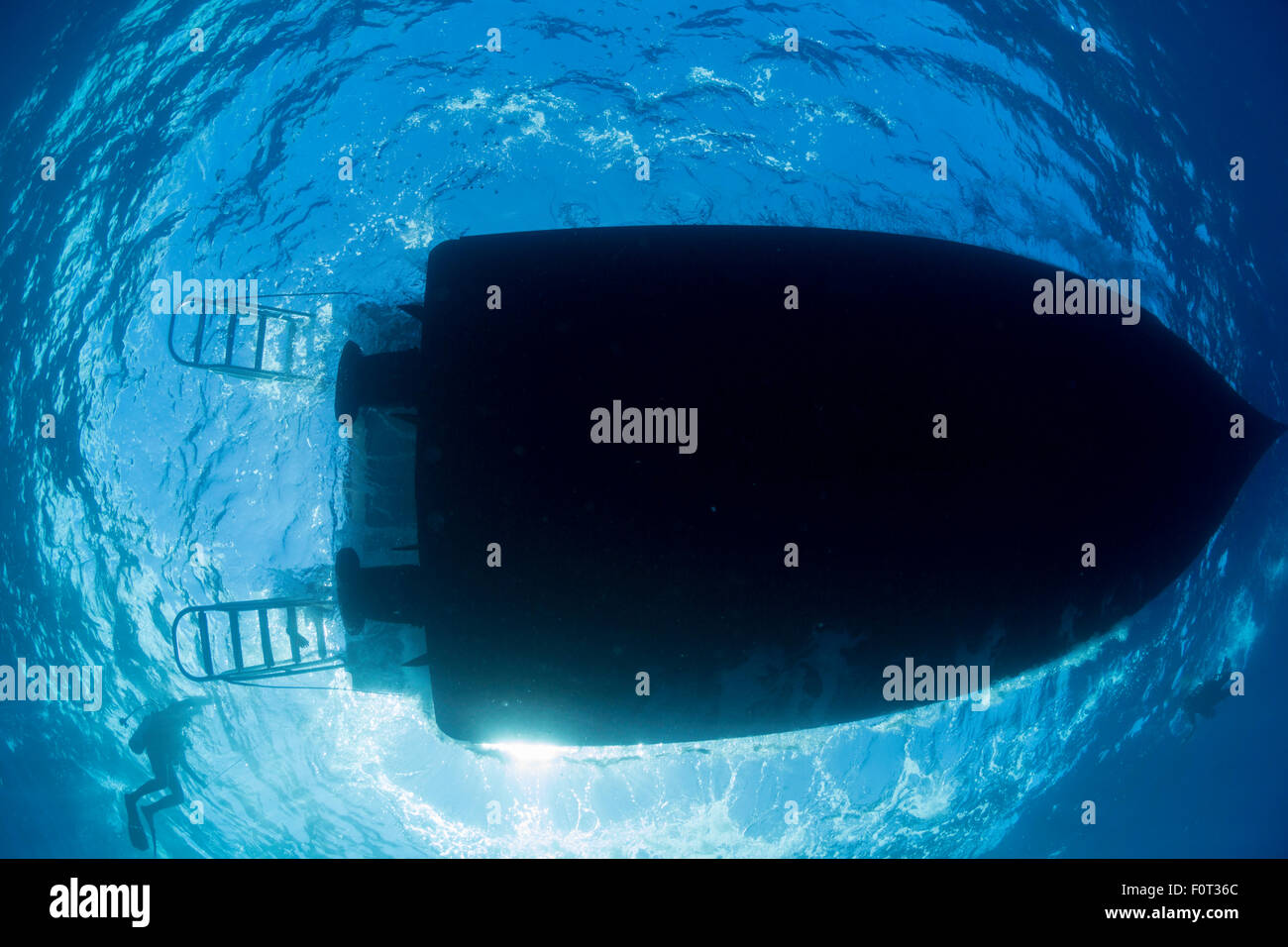 Divers (MR) return to their dive charter vessel at Molokini Island, Maui, Hawaii. Stock Photo