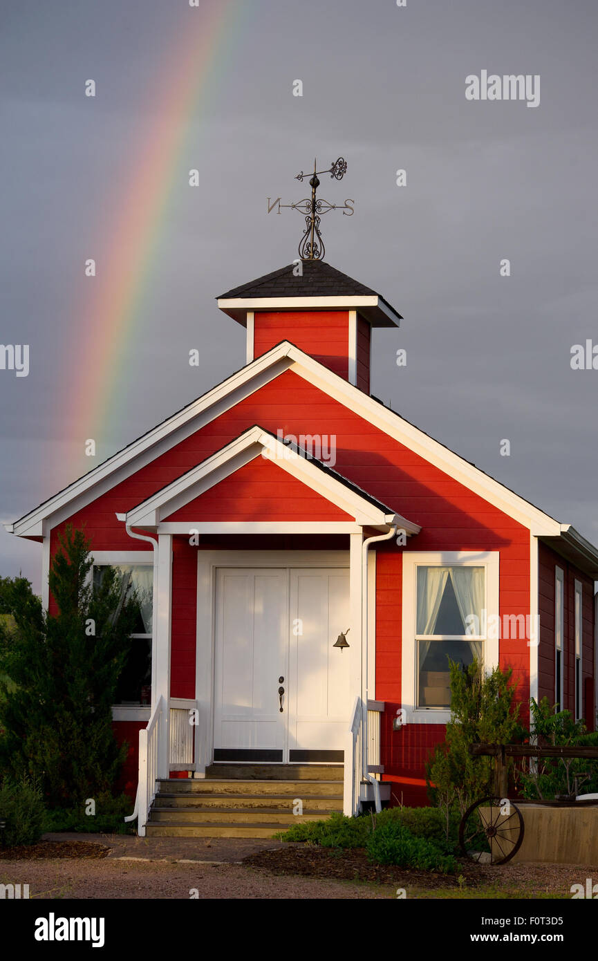 Rainbow over an old one room schoolhouse in Colorado. Stock Photo