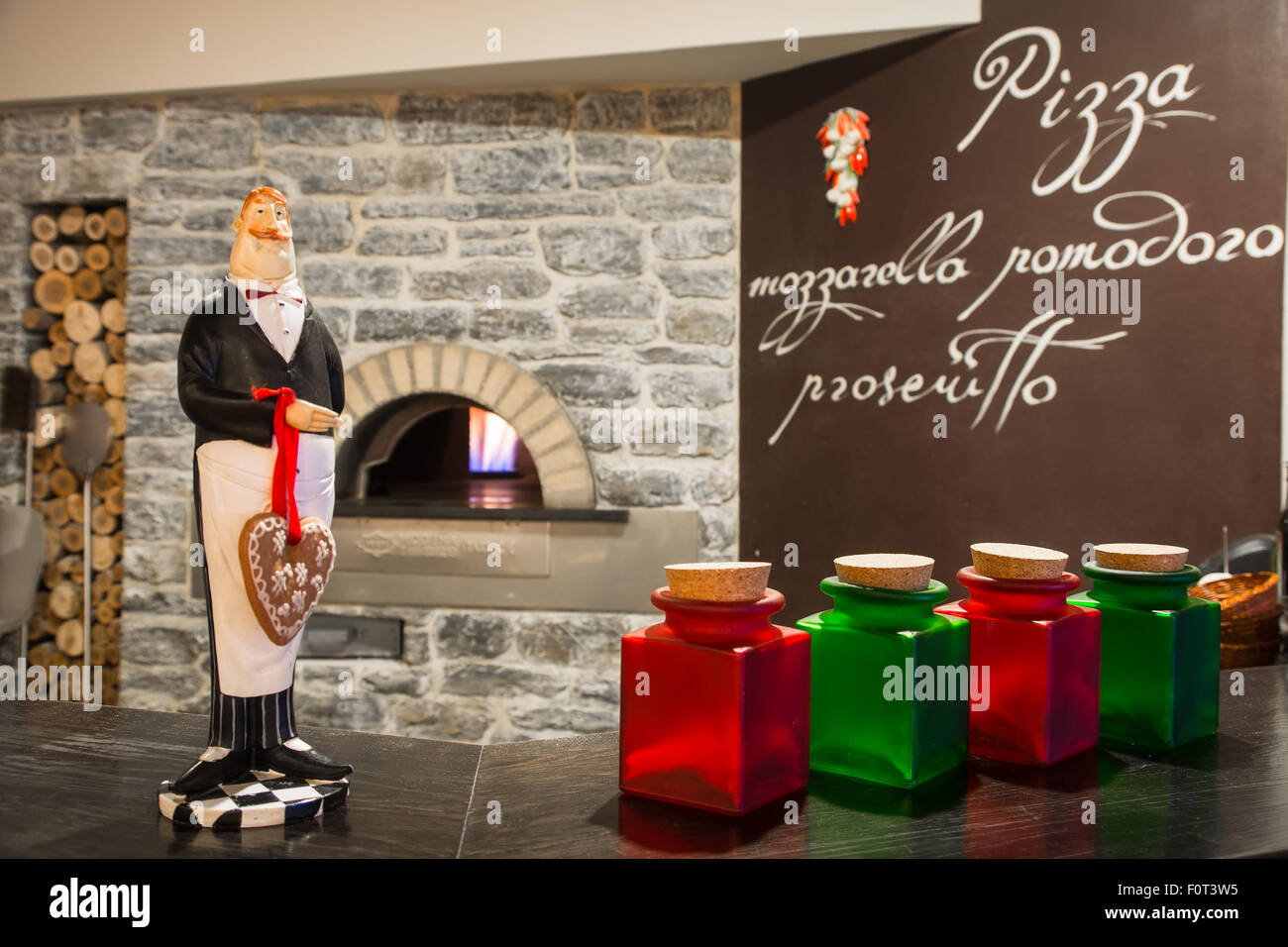 different jars and figure waiter standing at the bar Stock Photo