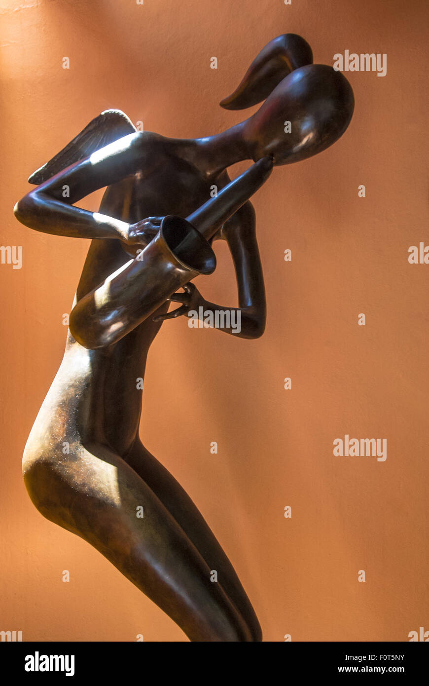 Sculpture of angelic woman playing a saxophone in the River Café,  Cuale River Island, Puerto Vallarta, Mexico Stock Photo