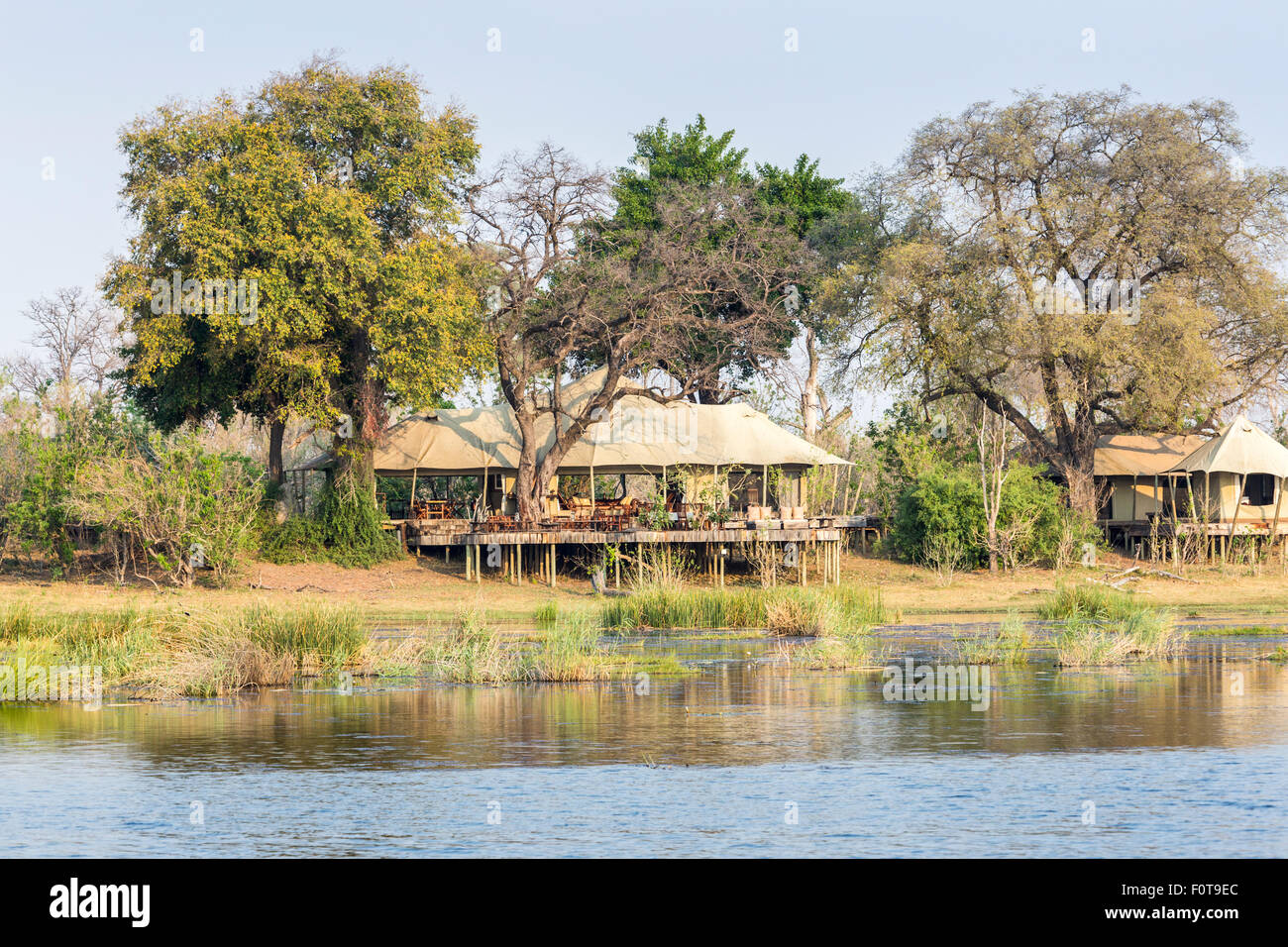 Zarafa Camp lakeside buildings on wooden stilts by a lake, Selinda Concession, Okavango Delta, Kalahari, Kalahari, north Botswana, southern Africa Stock Photo