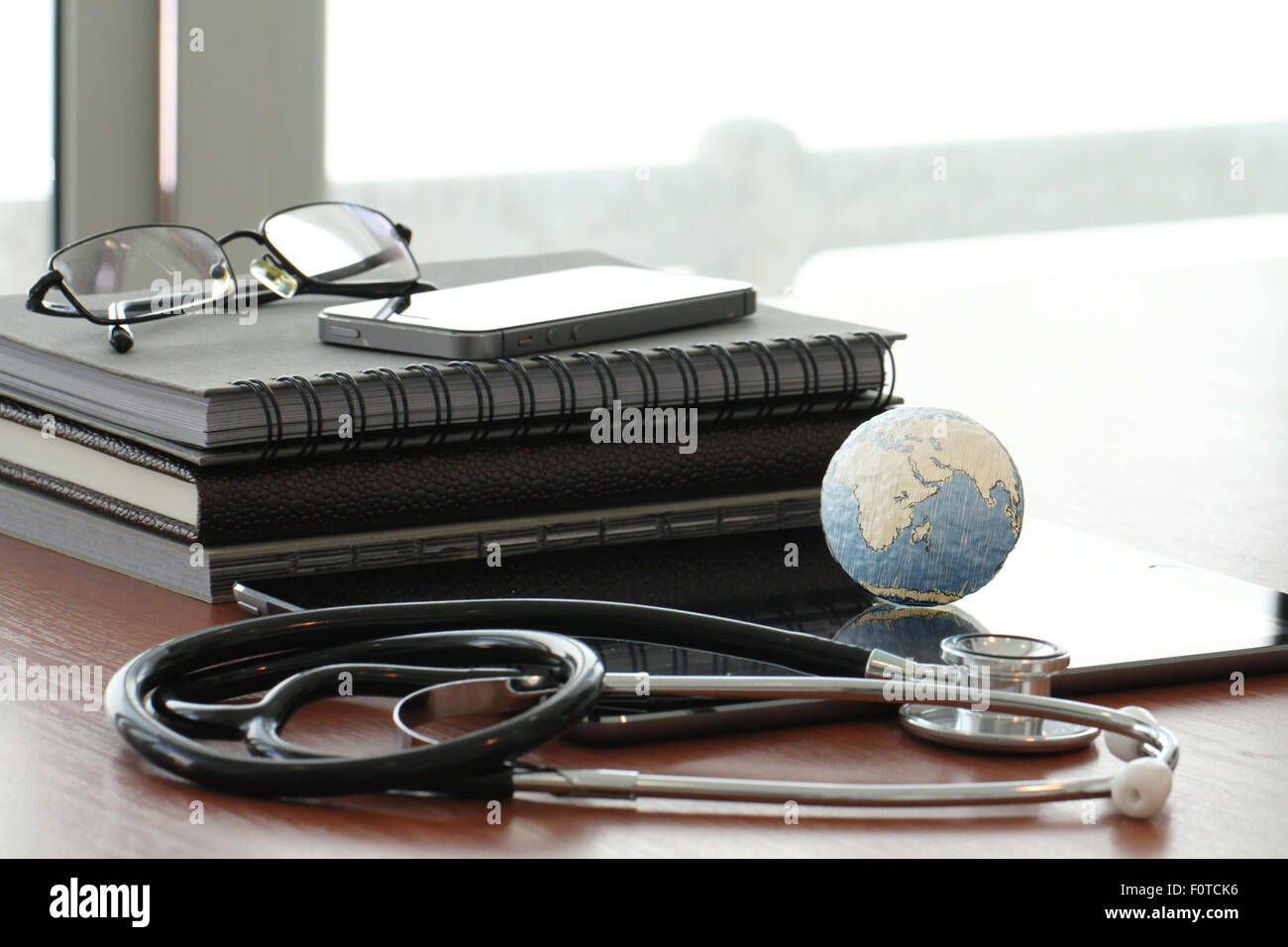 stethoscope and texture globe with digital tablet as medical network concept Stock Photo