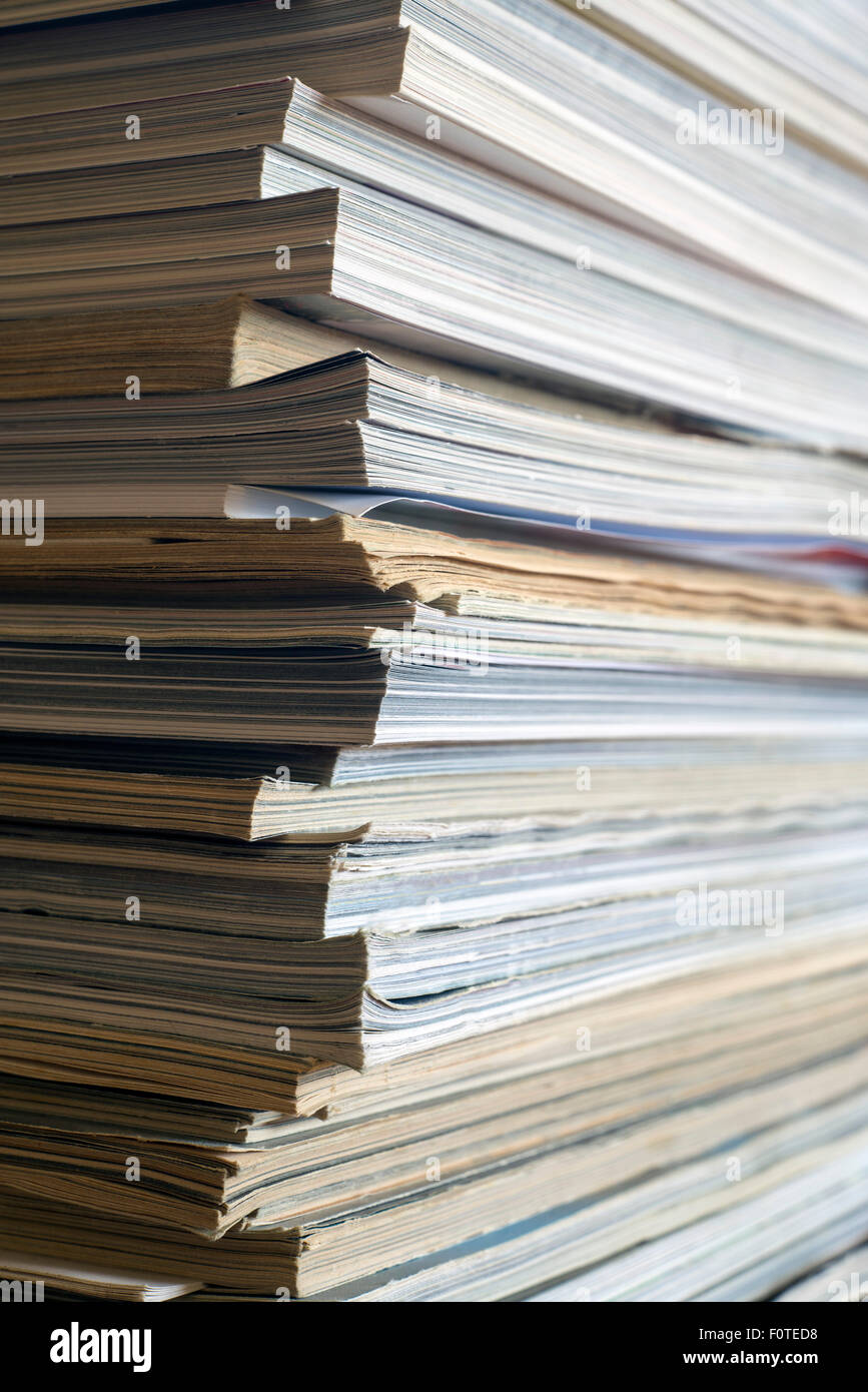 Closeup of a messy pile of old magazines with bending pages Stock Photo