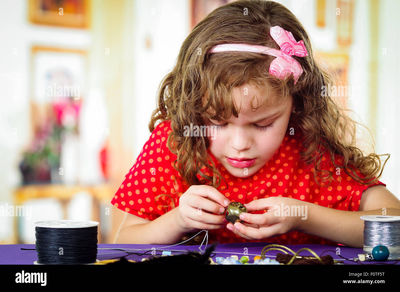 Adorable little girl making crafts Stock Photo
