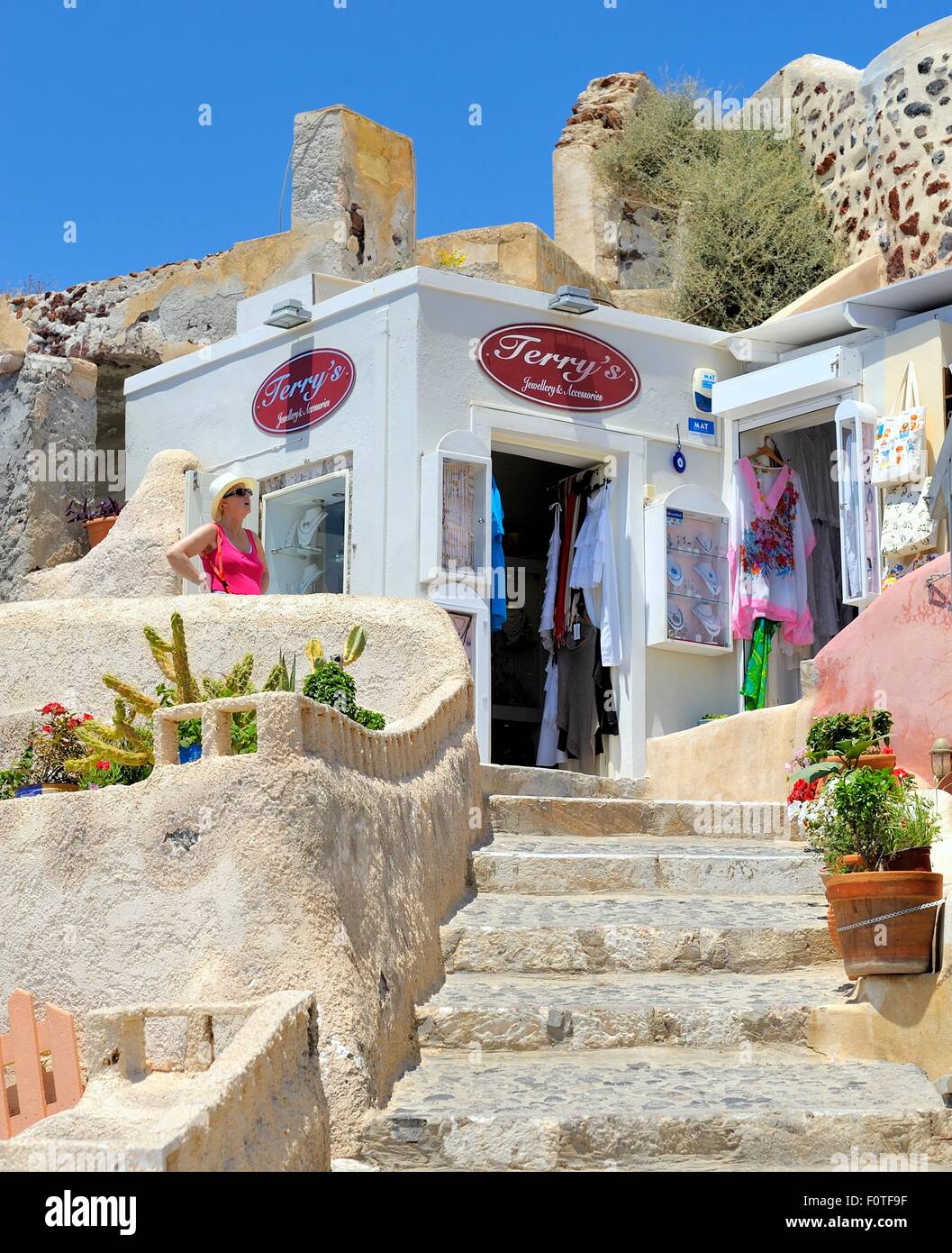 A female tourist outside a souvenir shop in Oia Santorini Greece Stock Photo