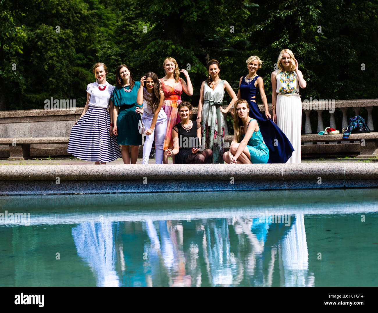A big group of girls (females) posing in a front of a camera before prom ceremony Stock Photo