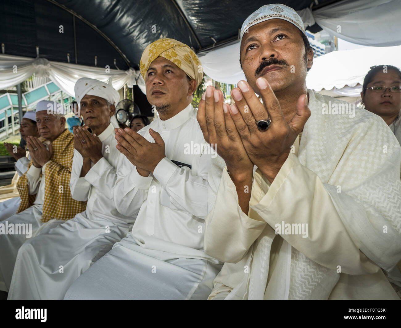 Bangkok, Thailand. 21st Aug, 2015. Muslim Imams participate in the Muslim prayer service at Central World to honor the dead from the Erawan Shrine bombing. The Bangkok Metropolitan Administration (BMA) held a religious ceremony Friday for the Ratchaprasong bomb victims. The ceremony started with a Brahmin blessing at Erawan Shrine, which was the target of a bombing Monday night. After the blessing people went across the street to the plaza in front of Central World mall for an interfaith religious service. Credit:  ZUMA Press, Inc./Alamy Live News Stock Photo