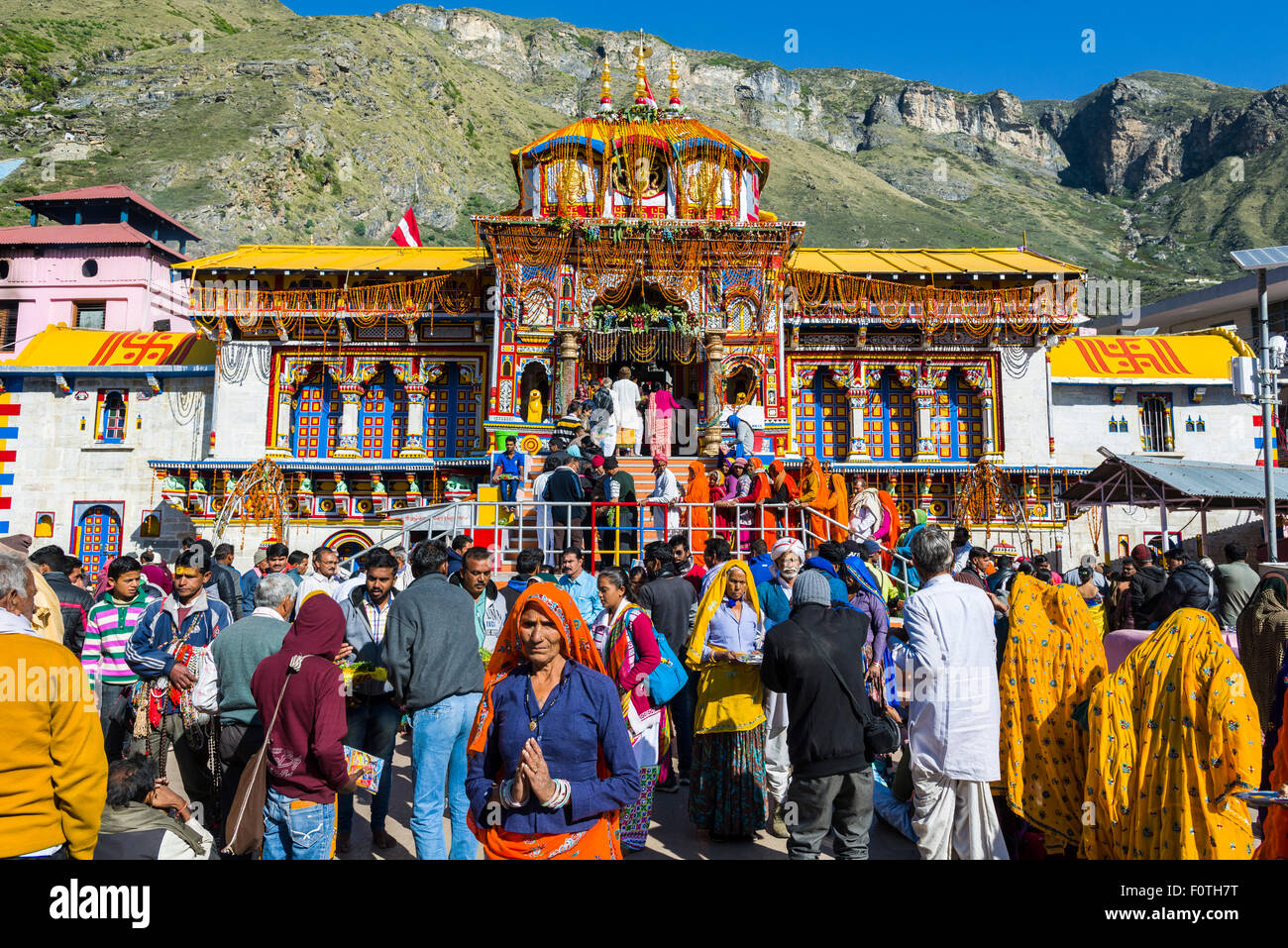 Many pilgrims are gathering in front of the colourful Badrinath Temple, one of the Dschar Dham destinations, Badrinath Stock Photo