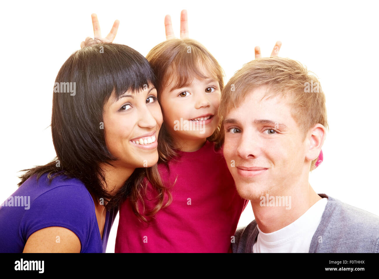 Family portrait with fingers behind the heads Stock Photo