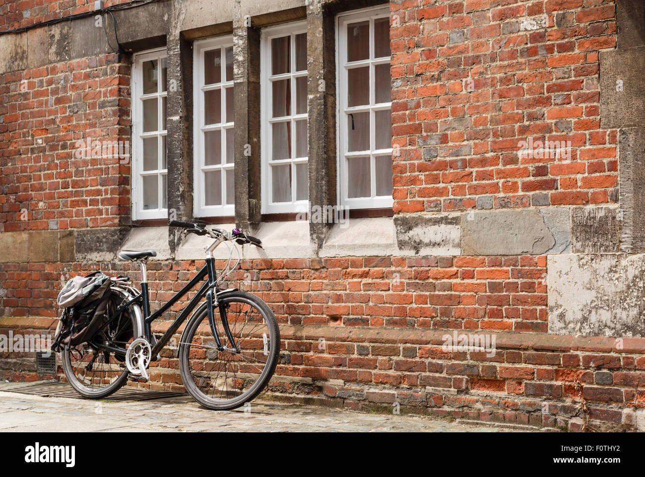 Retro bike against the brick wall of an old building with nobody. Stock Photo
