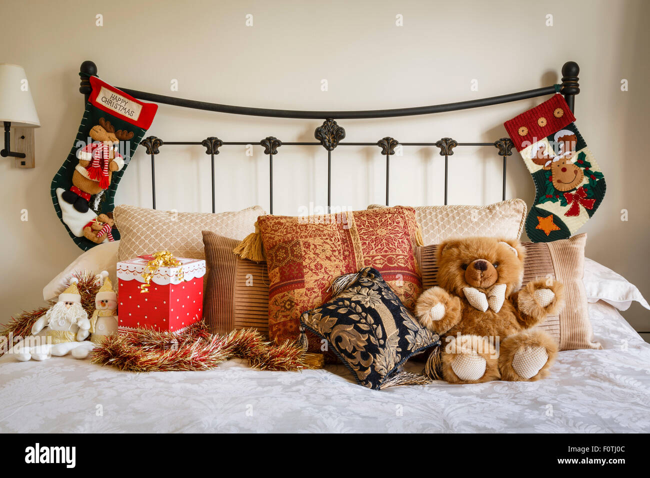 Cozy Christmas bedroom scene with Christmas stockings on bedstead Stock Photo