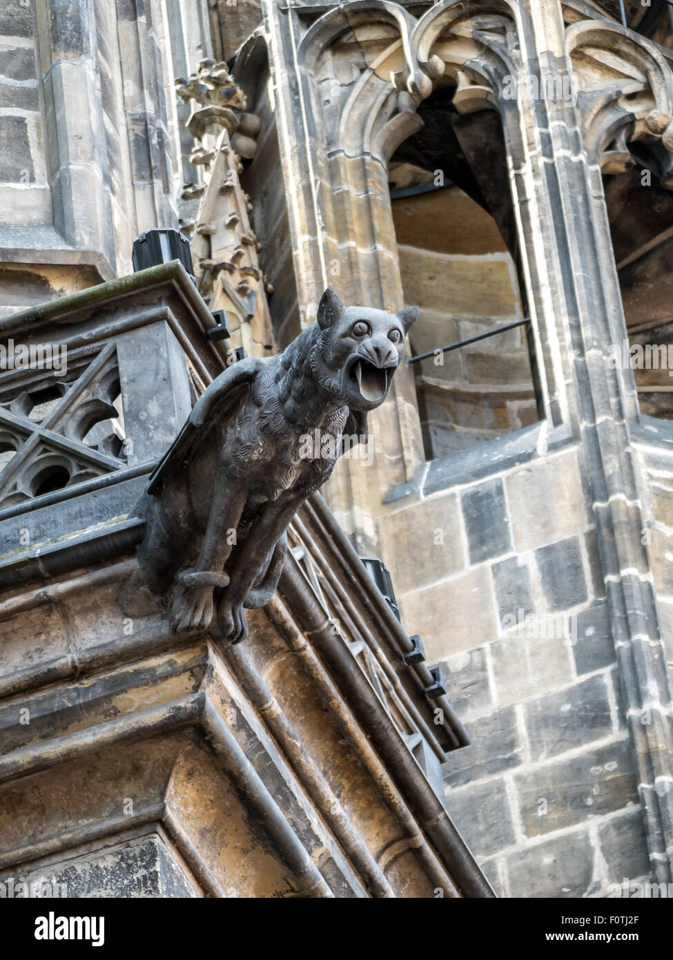One of many stone demon gargoyles as a part of Metropolitan Cathedral of Saints Vitus, Wenceslaus and Adalbert, Prague Castle Stock Photo