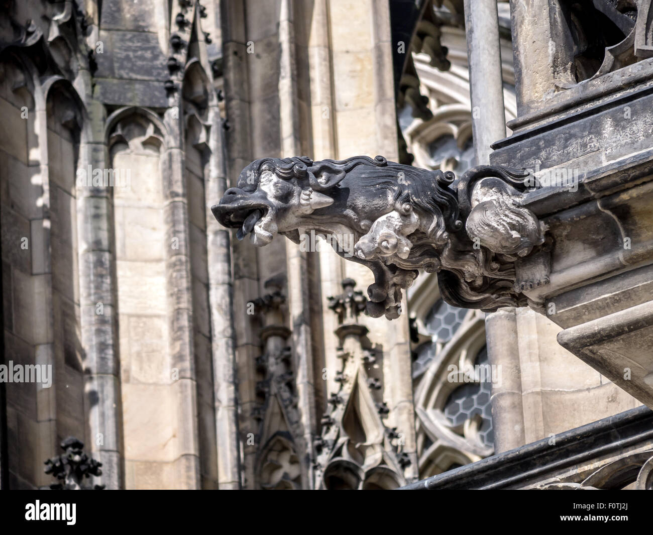 One of many stone demon gargoyles as a part of Metropolitan Cathedral of Saints Vitus, Wenceslaus and Adalbert, Prague Castle Stock Photo