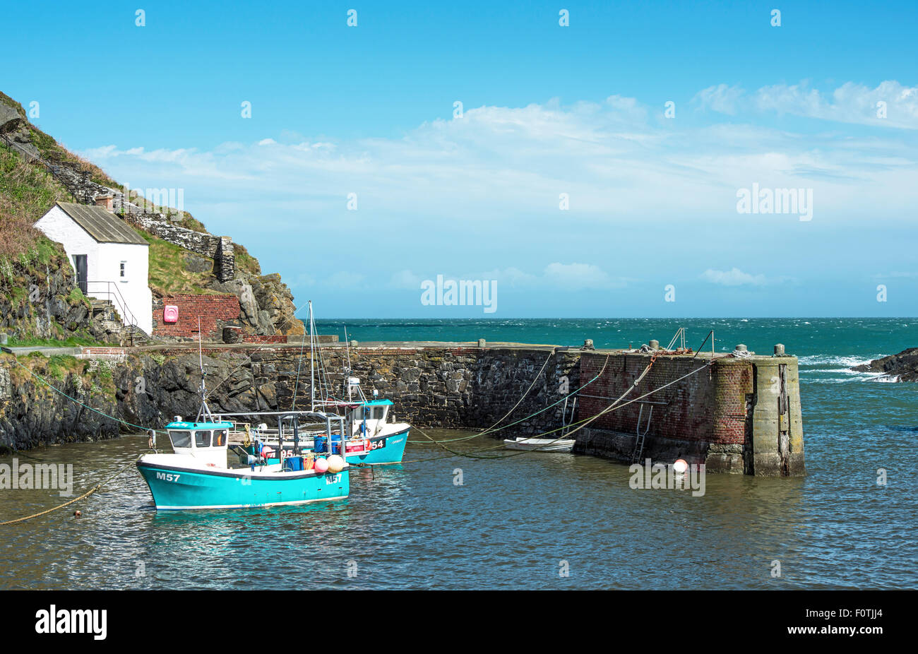 Porthgain Harbour with moored boats Pembrokeshire Coast National Park West Wales UK Stock Photo