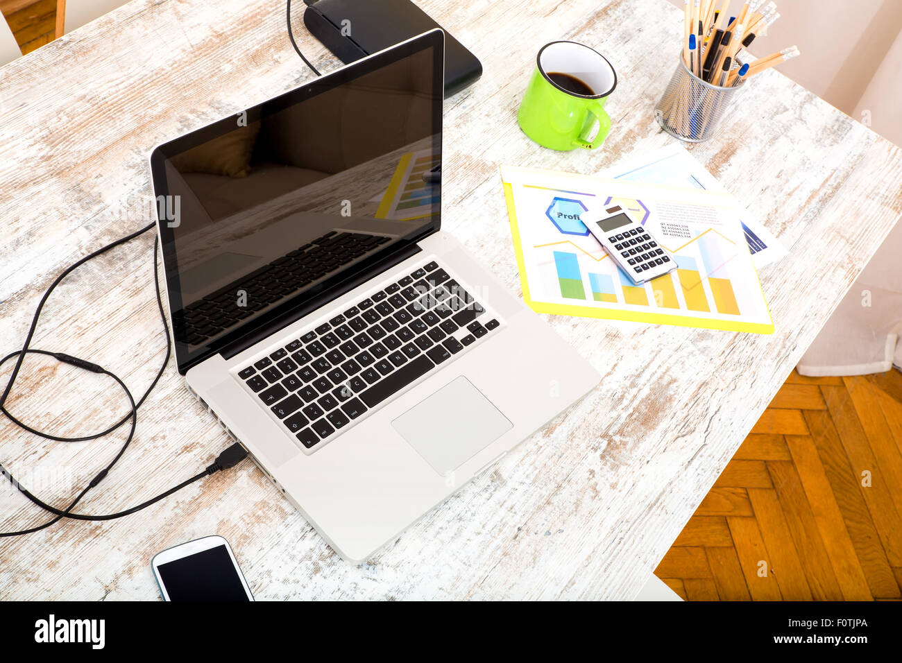 A modern home office setup on a wooden Table. Stock Photo