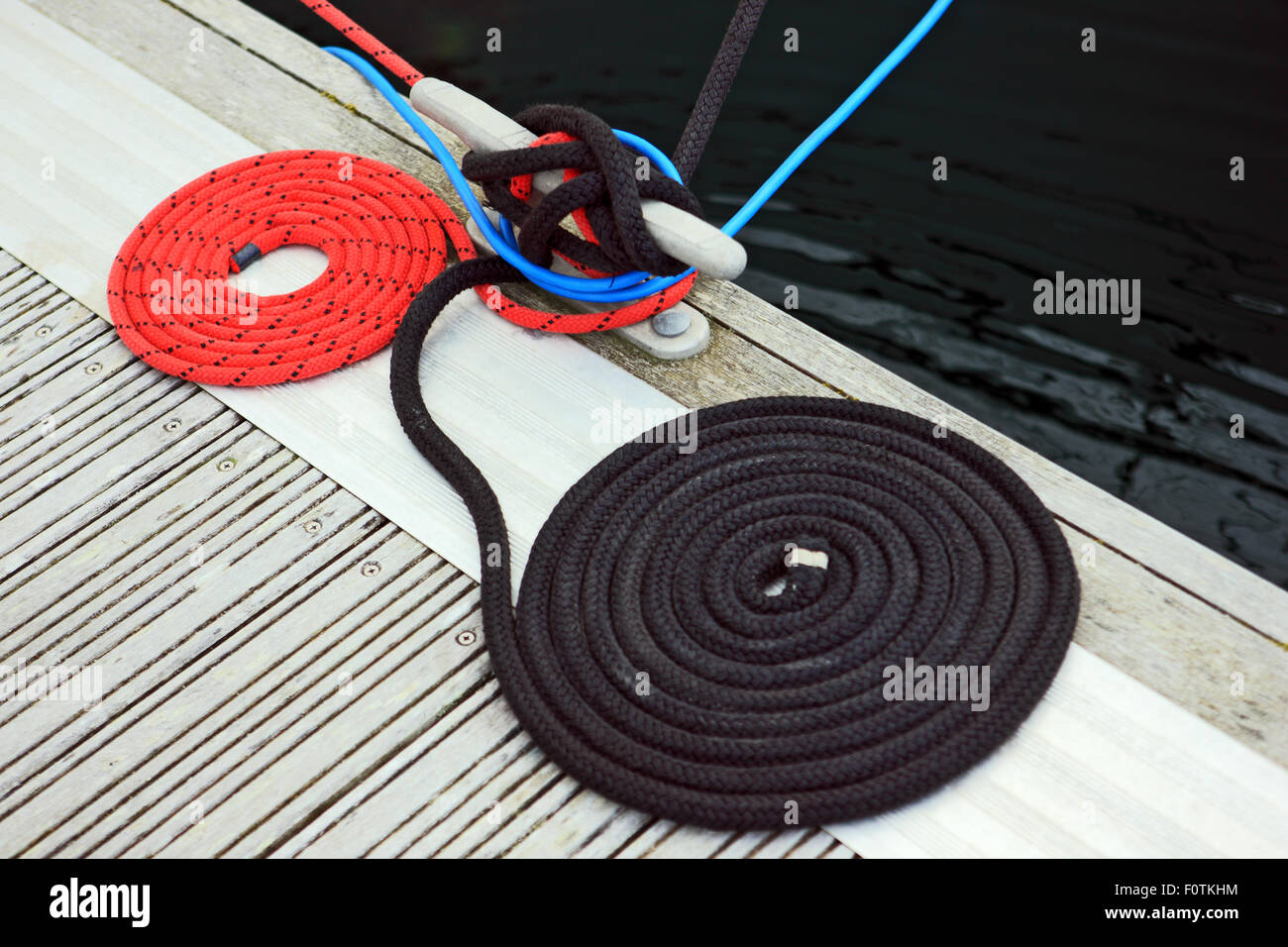 Coiled ropes on the quayside Stock Photo