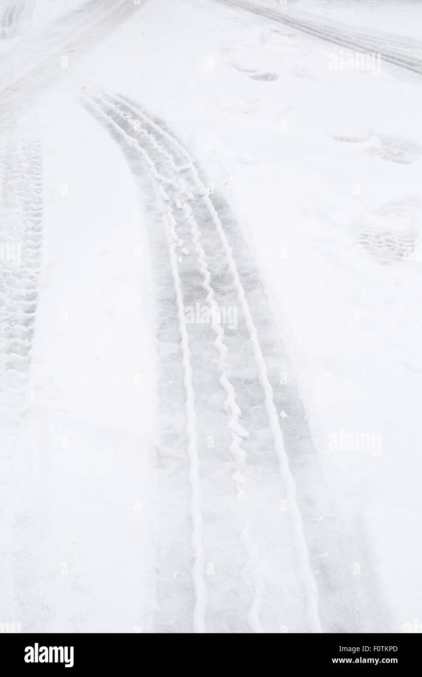 Tyre tracks on ice and snow on a highway Stock Photo