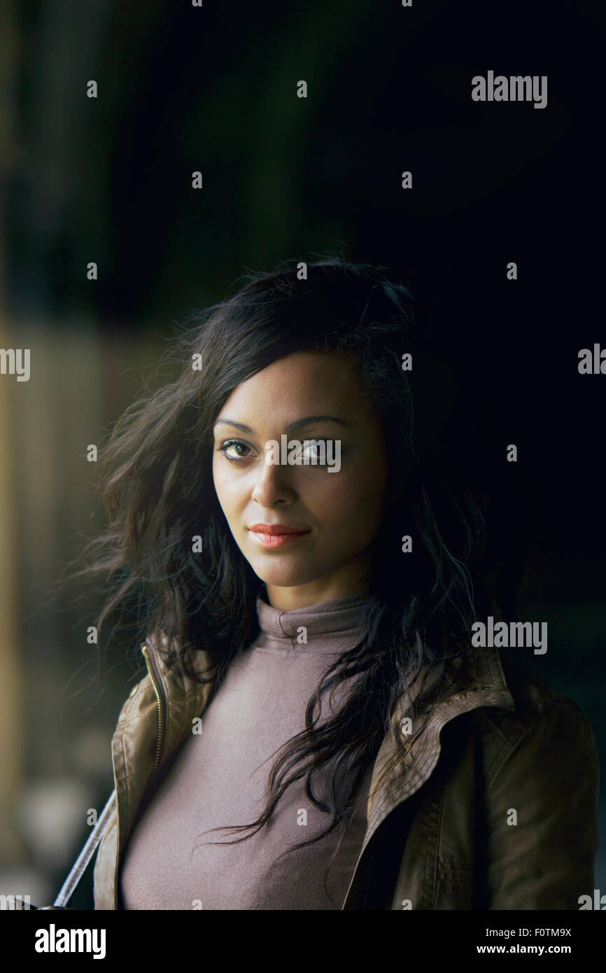 Natural light portrait of attractive Asian woman in cloisters at Norwich Cathedral Stock Photo