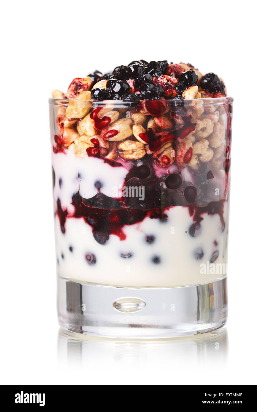 Parfait-style healthy layered snack or dessert with yogurt,bilberry jam,fresh bilberries,puffed honey wheat in glass Stock Photo