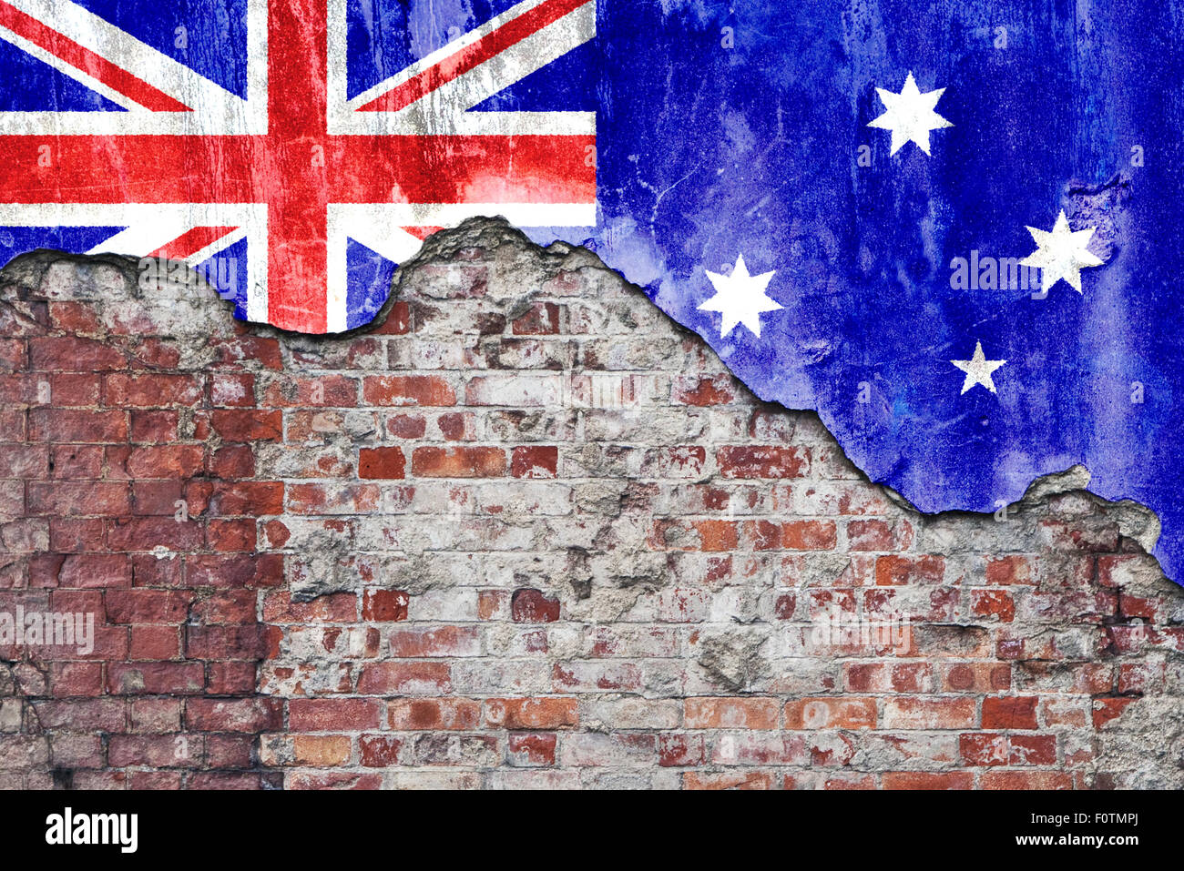 Grungy old brick wall with Australian flag on broken render surface ...