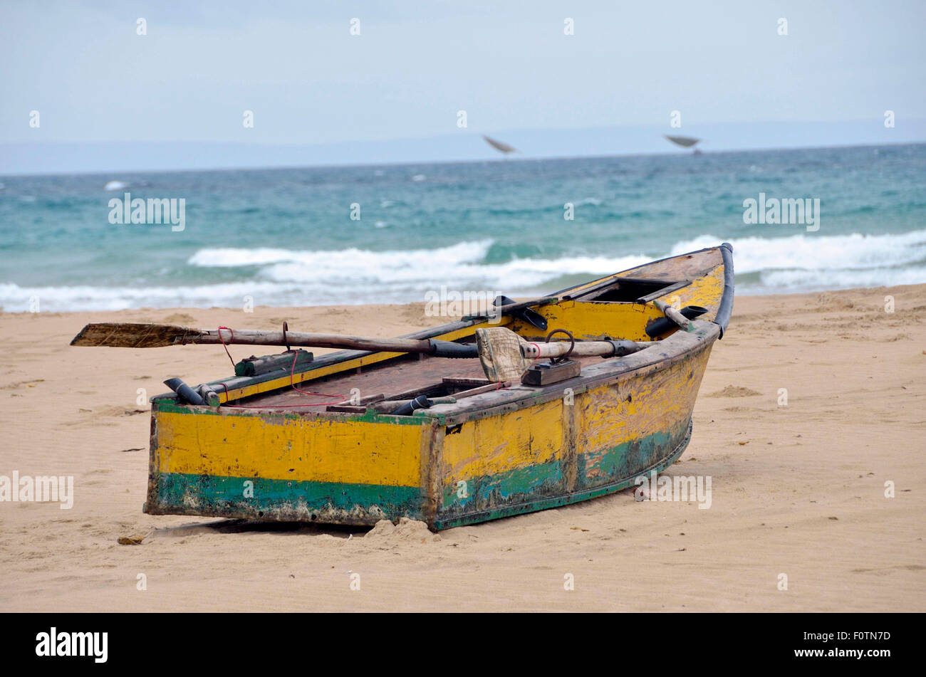 Old dilapidated fishing boats lying on the beach at Inhambane, Mozambique. These are unsafe and home repaired but used daily Stock Photo