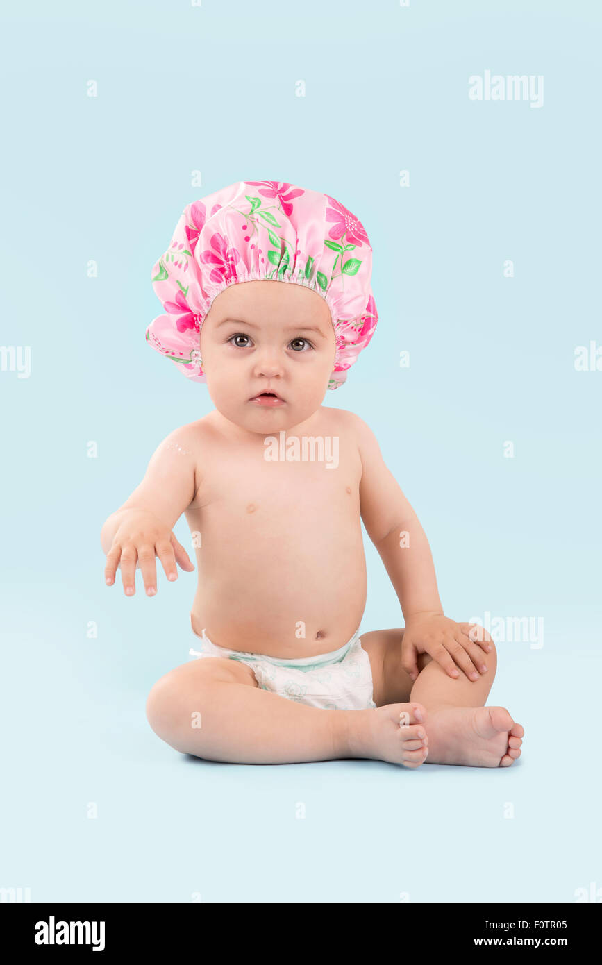 Lovely baby with shower cap isolated in a light background Stock Photo