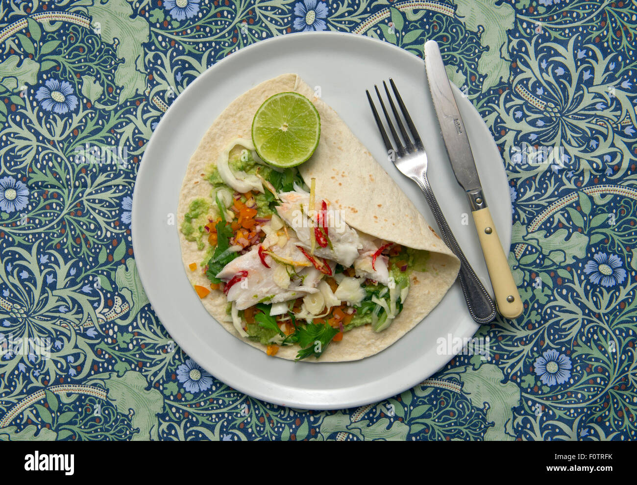 Spiced fish with taco & guacomole. Stock Photo