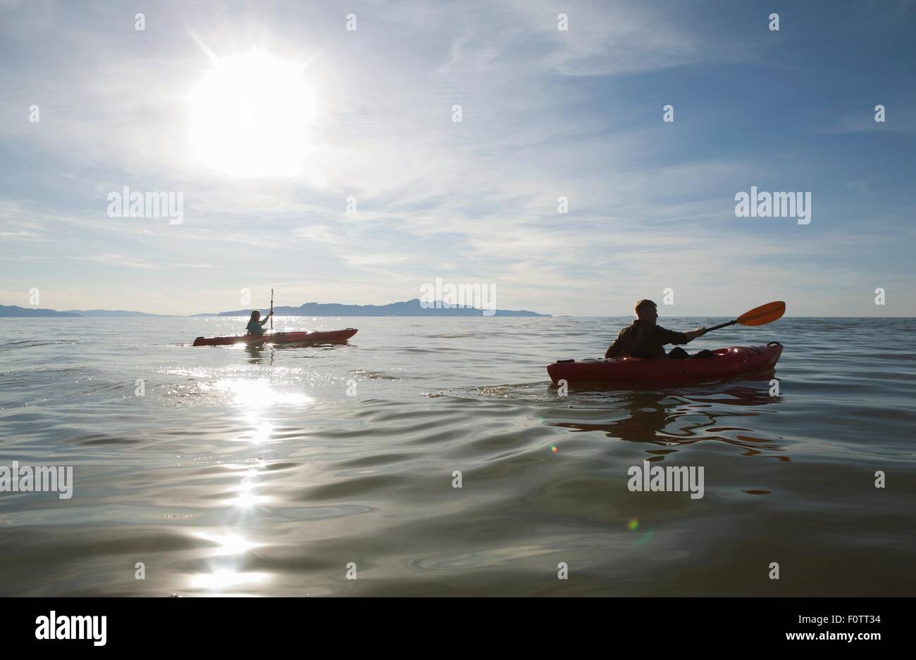 Couple kayaking, sunlight reflecting on water, Great Salt Lake, Utah, USA Stock Photo