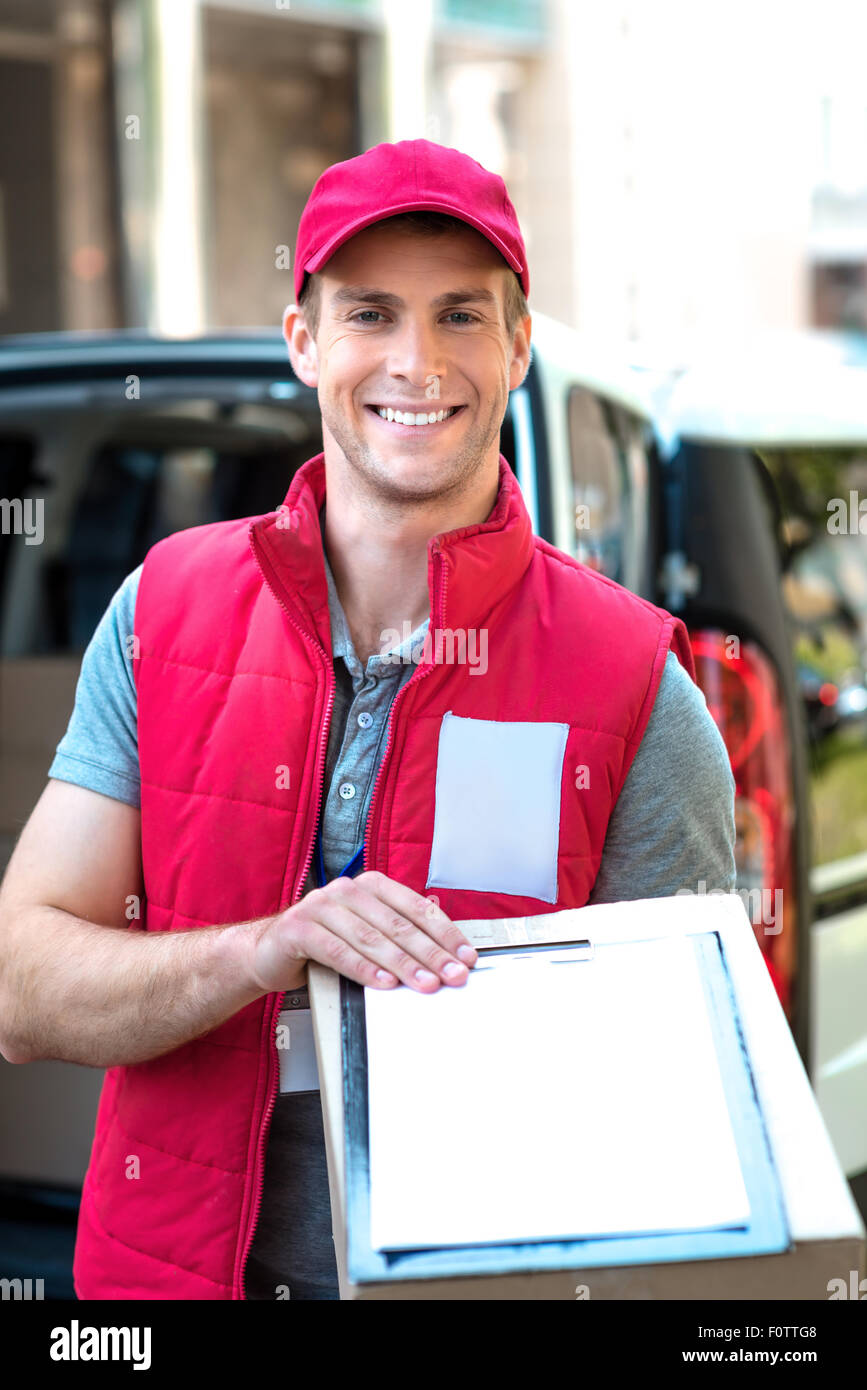 Courier Delivering Package By Van Stock Photo