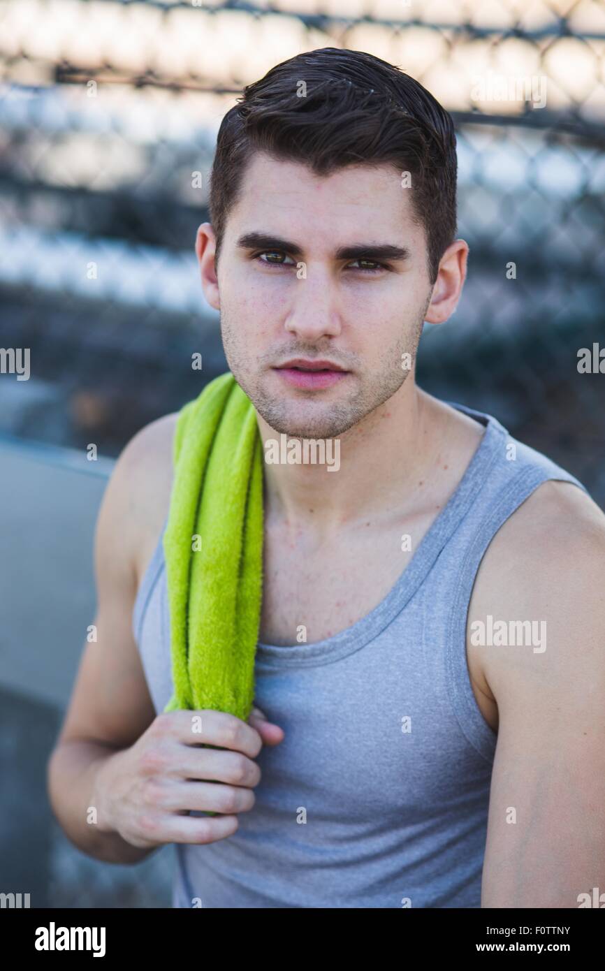 Portrait of young male basketball player with towel on shoulder Stock Photo