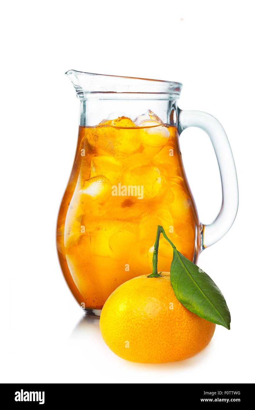 Tangerine lemonade with ice in a pitcher. Jug full of iced tangerine