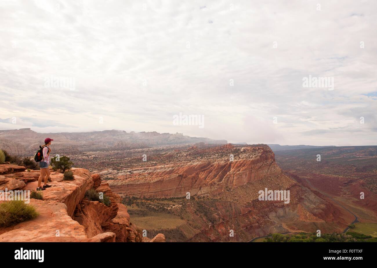 Female hiker looking out over Capitol Reef National Park, Torrey, Utah, USA Stock Photo