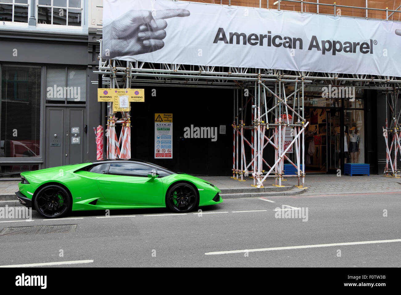Green Lamborghini parked outside American Apparel shop London, UK   KATHY DEWITT Stock Photo