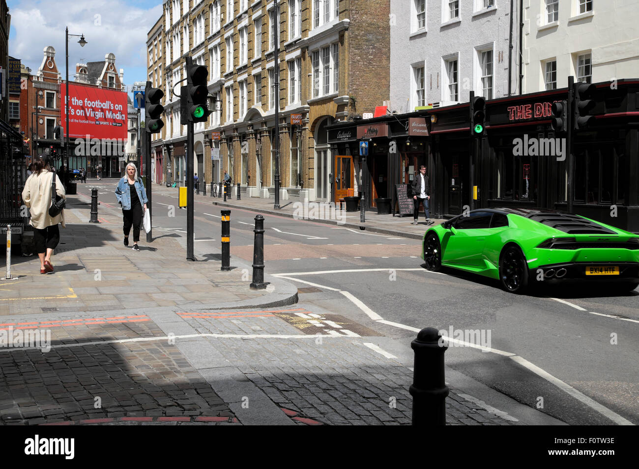 Orange Lamborghini. People watch supercars, in Sloane Street for Supercar  Sunday, Knightsbridge, London, UK Stock Photo - Alamy