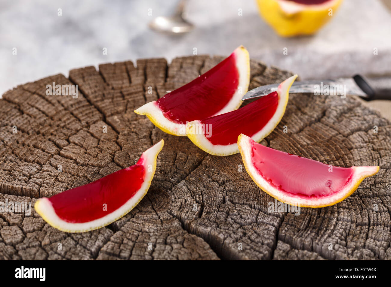 Lemon tequila strawberry jelly (jello) shots on a old wooden wheel