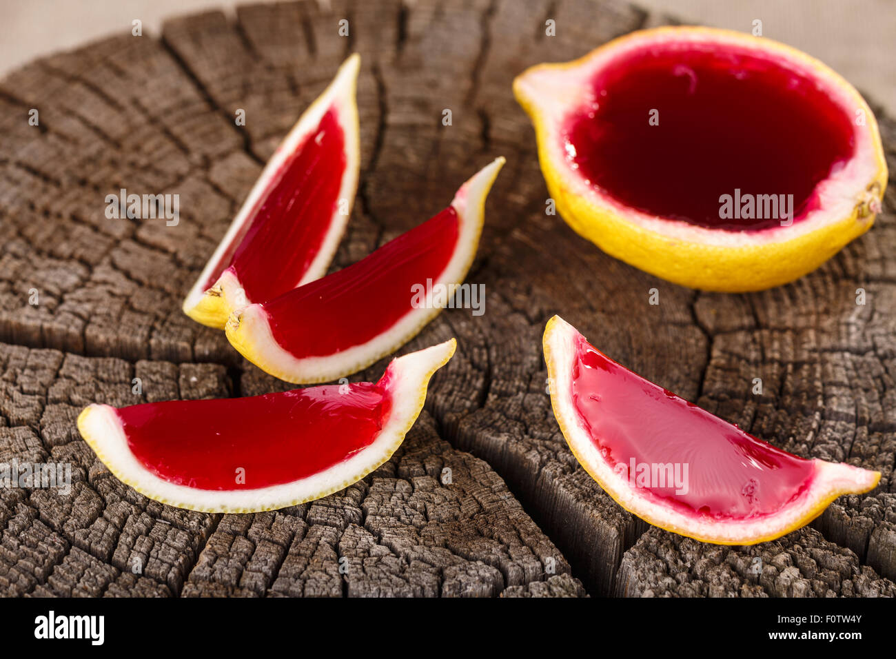 Lemon tequila strawberry jelly (jello) shots on a old wooden wheel