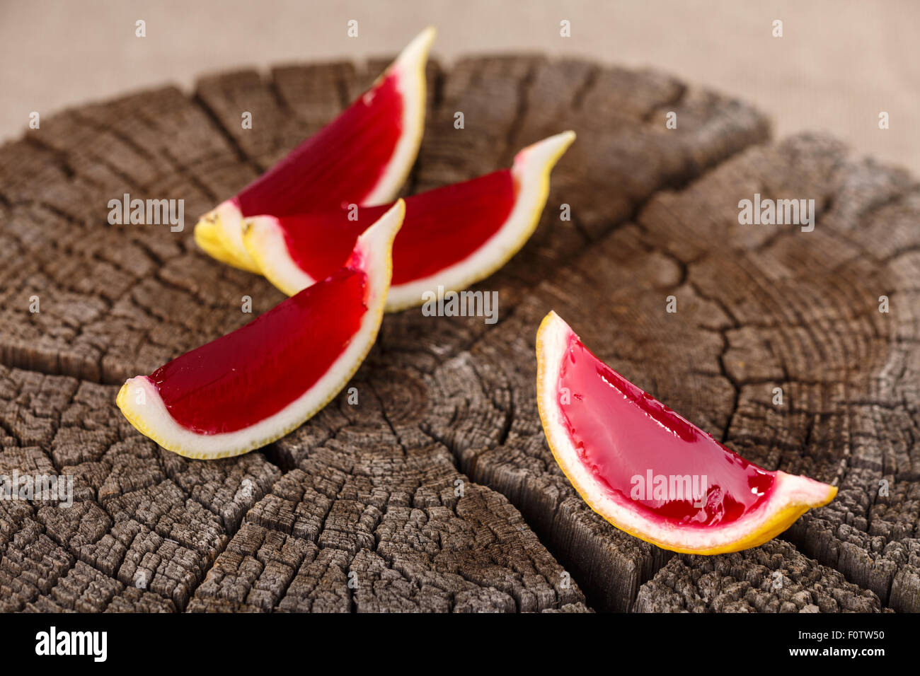 Lemon tequila strawberry jelly (jello) shots on a old wooden wheel