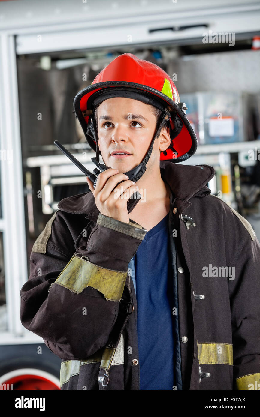 Male Firefighter Using Walkie Talkie At Fire Station Stock Photo - Alamy
