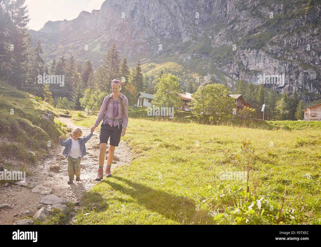 Mother and son hiking along pathway, Benediktbeuern, Bavaria, Germany Stock Photo