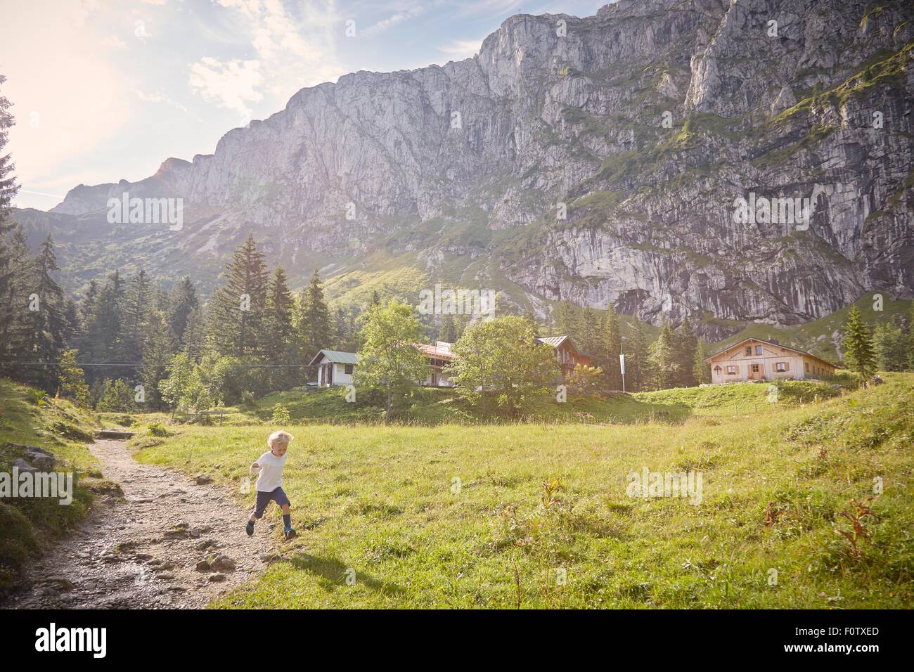 Boy running in rural setting, Benediktbeuern, Bavaria, Germany Stock Photo
