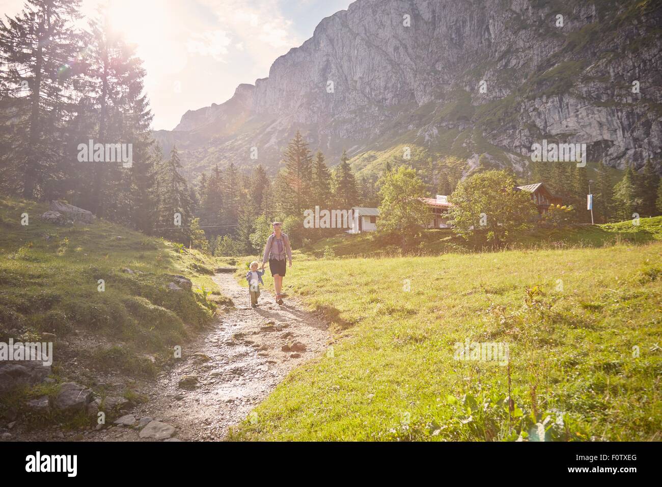 Mother and son hiking along pathway, Benediktbeuern, Bavaria, Germany Stock Photo