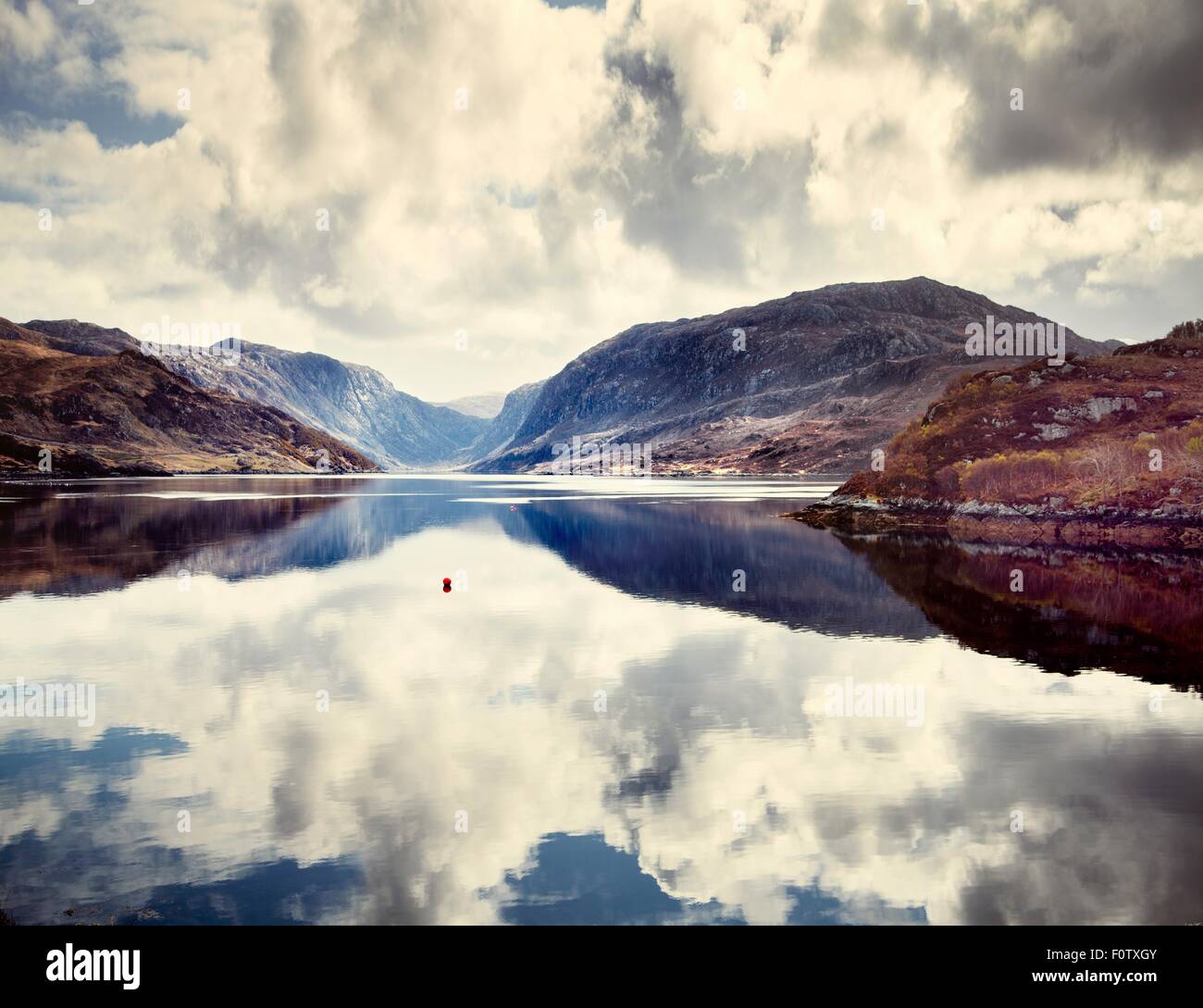 Reflection of clouds and mountains on waters surface, Assynt, Scotland Stock Photo