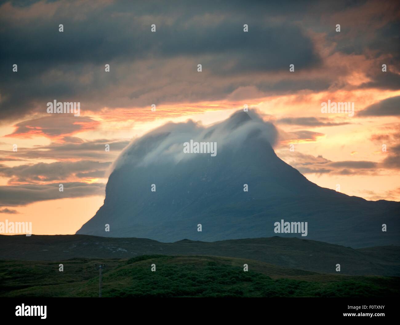 Low cloud rolling over top of Stac pollaidh mountain at dusk, Assynt, Scotland, UK Stock Photo
