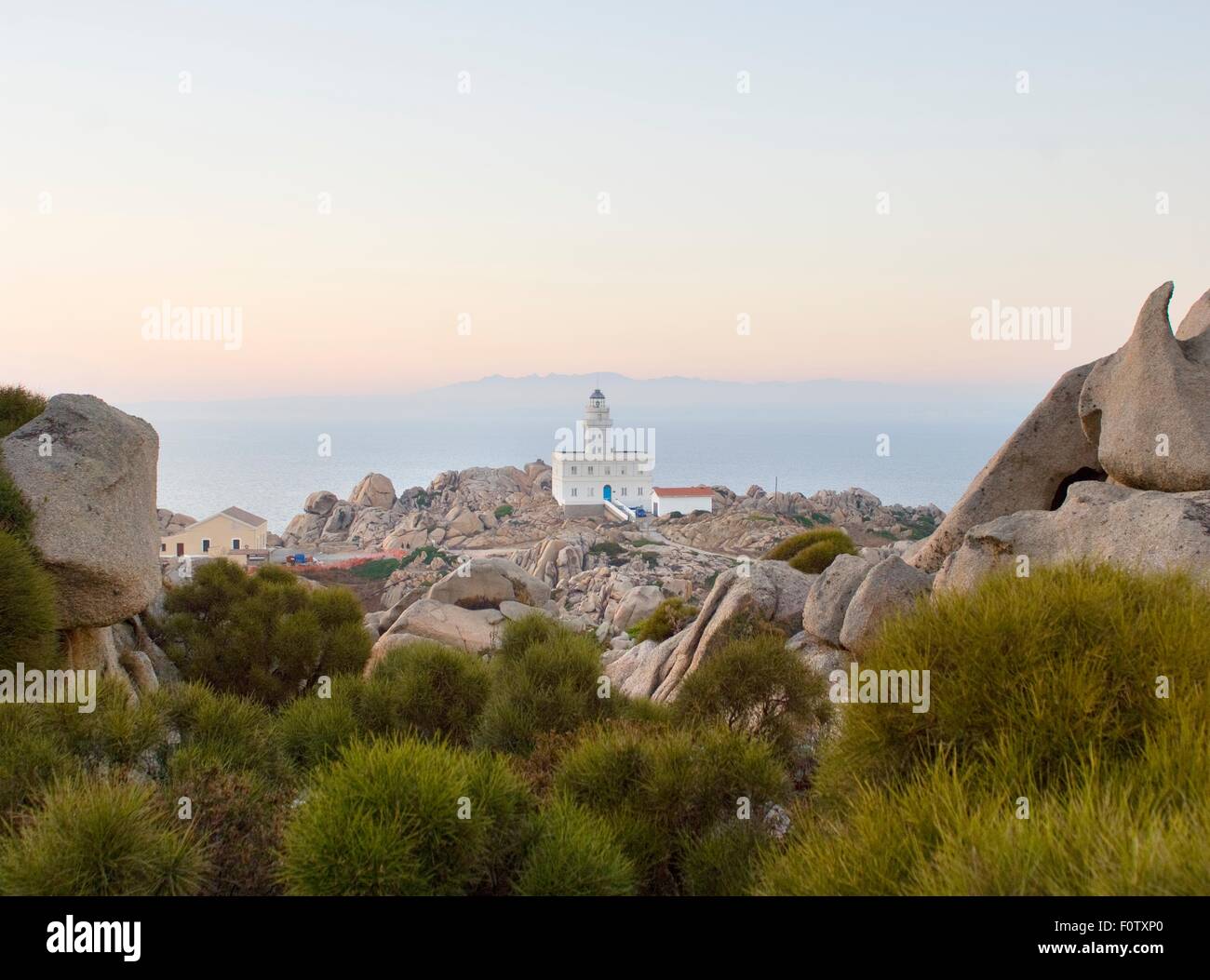 View of rocks and Cabo Testa lighthouse, Sardinia, Italy Stock Photo