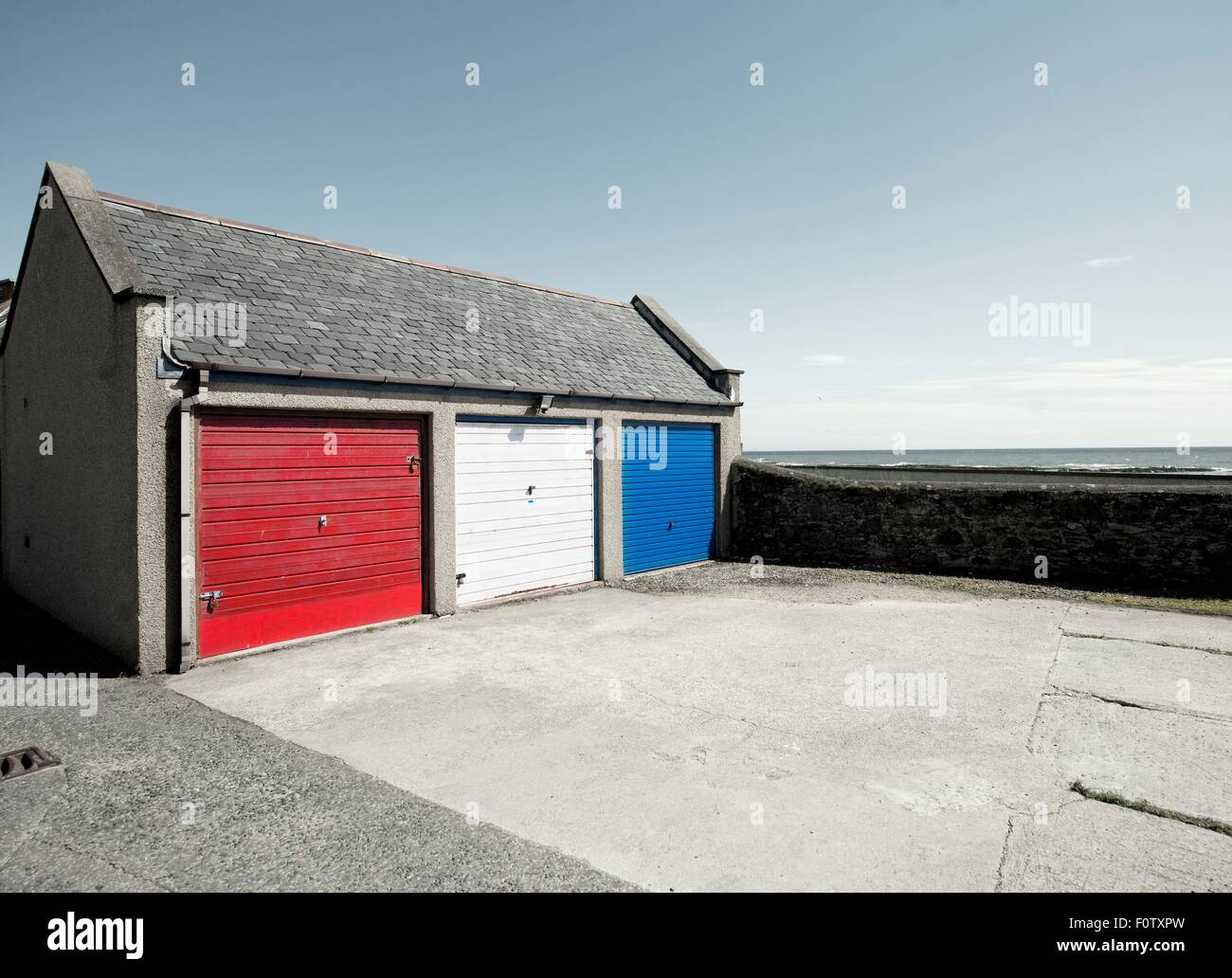 Garage doors painted red, white and blue, Johnshaven, Aberdeenshire, Scotland, UK Stock Photo