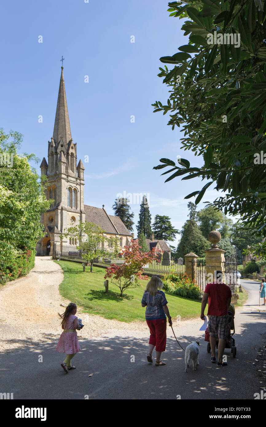 A young family visiting St. Mary's parish church in the Cotswold village of Batsford, Gloucestershire, England, UK Stock Photo