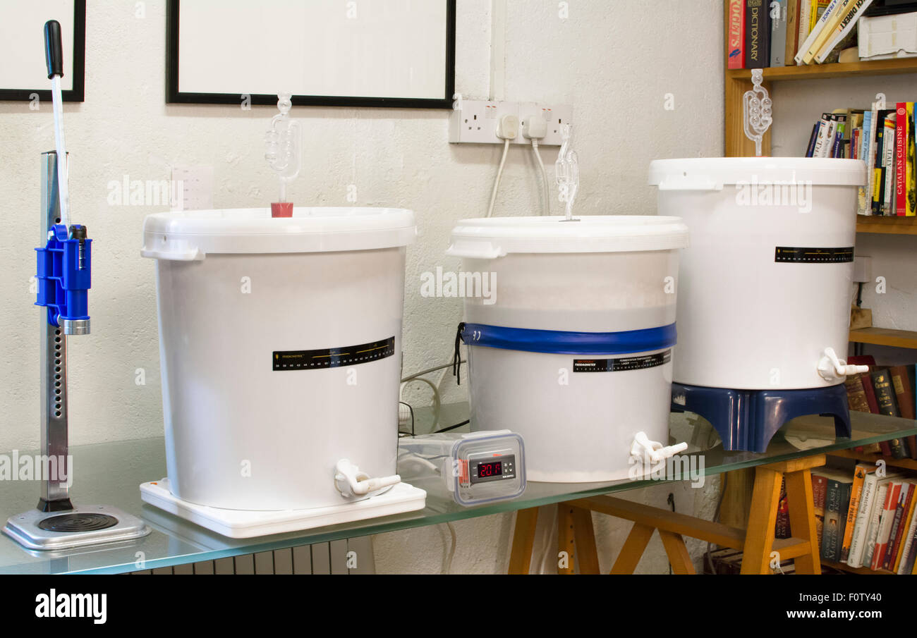 Homebrewing three fermentation vessels with airlocks in a home beer